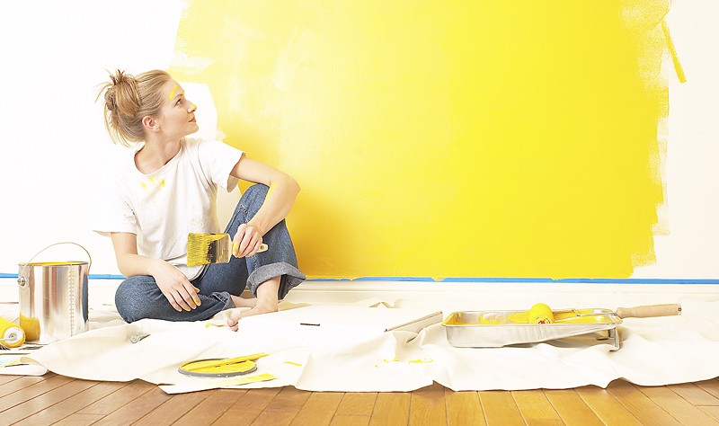 young woman coloring a wall