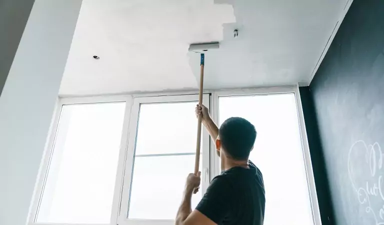 young man painting a ceiling